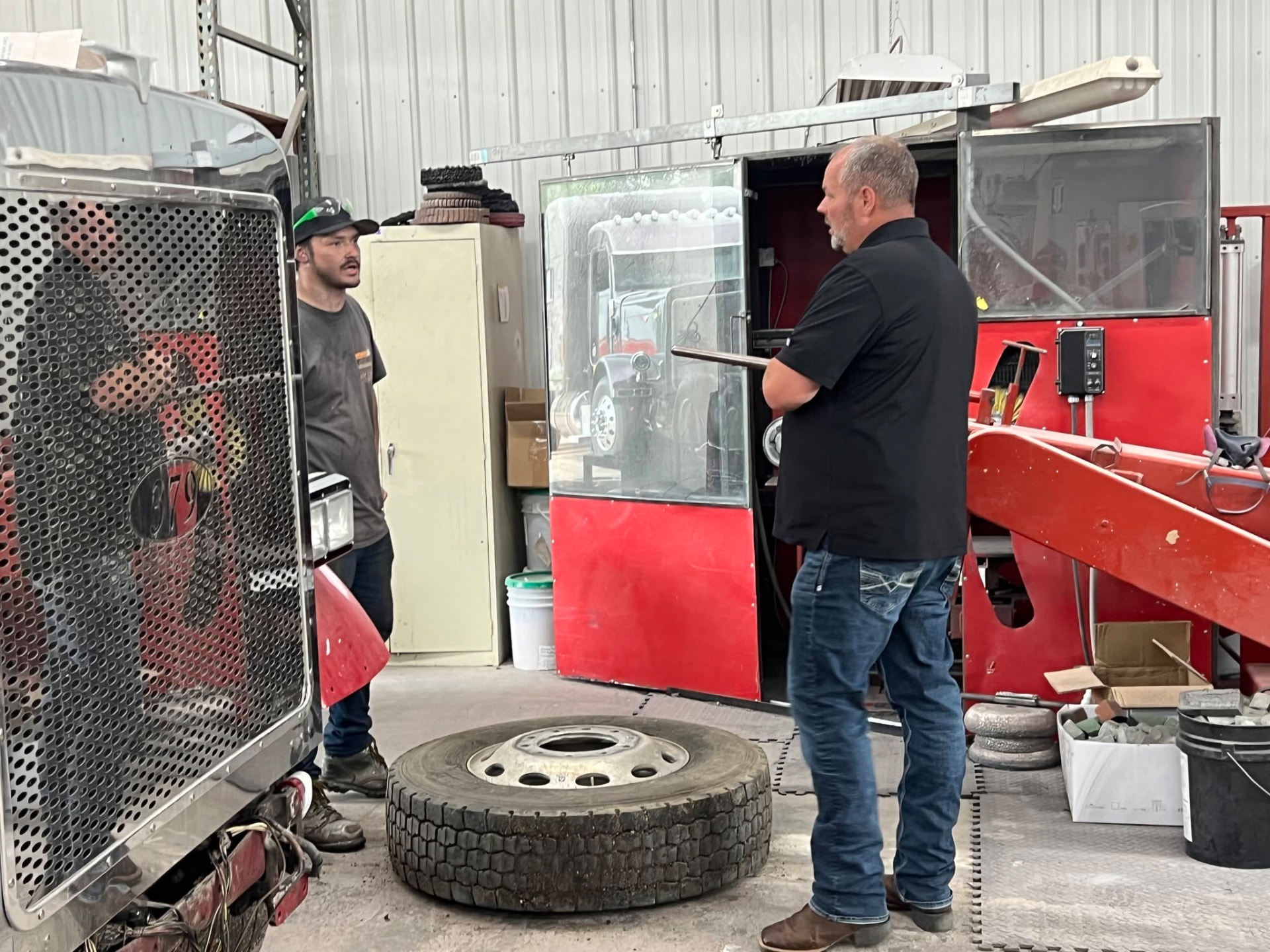Shop manager and diesel tech going over a repair on the shop floor
