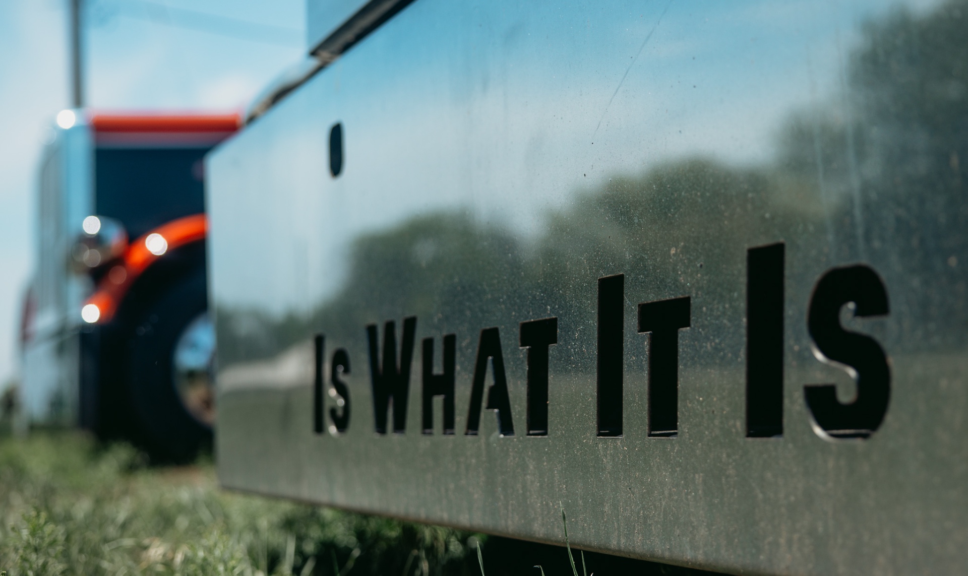 Is What It Is cut steel plate with Peterbilt behind
