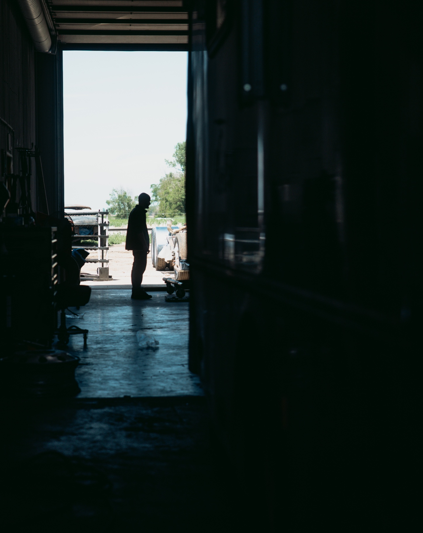 Tech silhouetted in the shop door